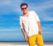 outdoor-fashion-portrait-handsome-man-posing-amazing-tropical-beach-nice-sunny-day-beautiful-view-blue-sky-ocean-wearing-casual-yellow-sorts-classic-white-shirt-sunglasses (1) 1
